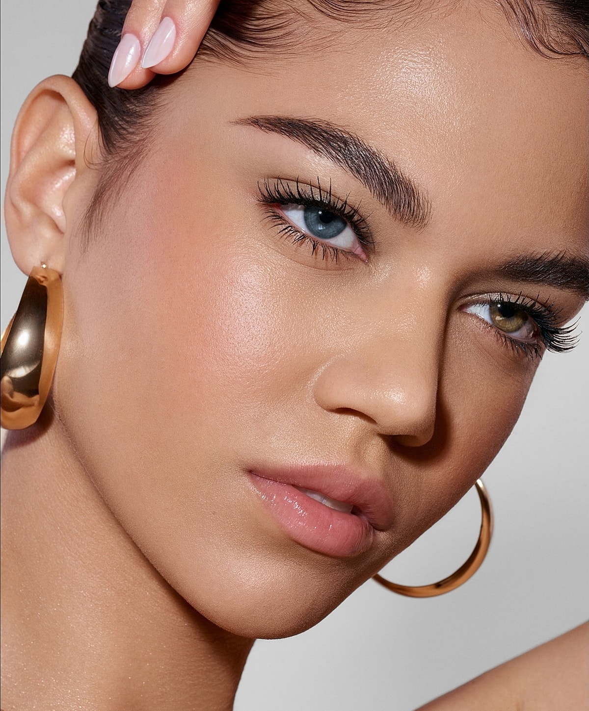 Close-up of a woman's face with earrings.