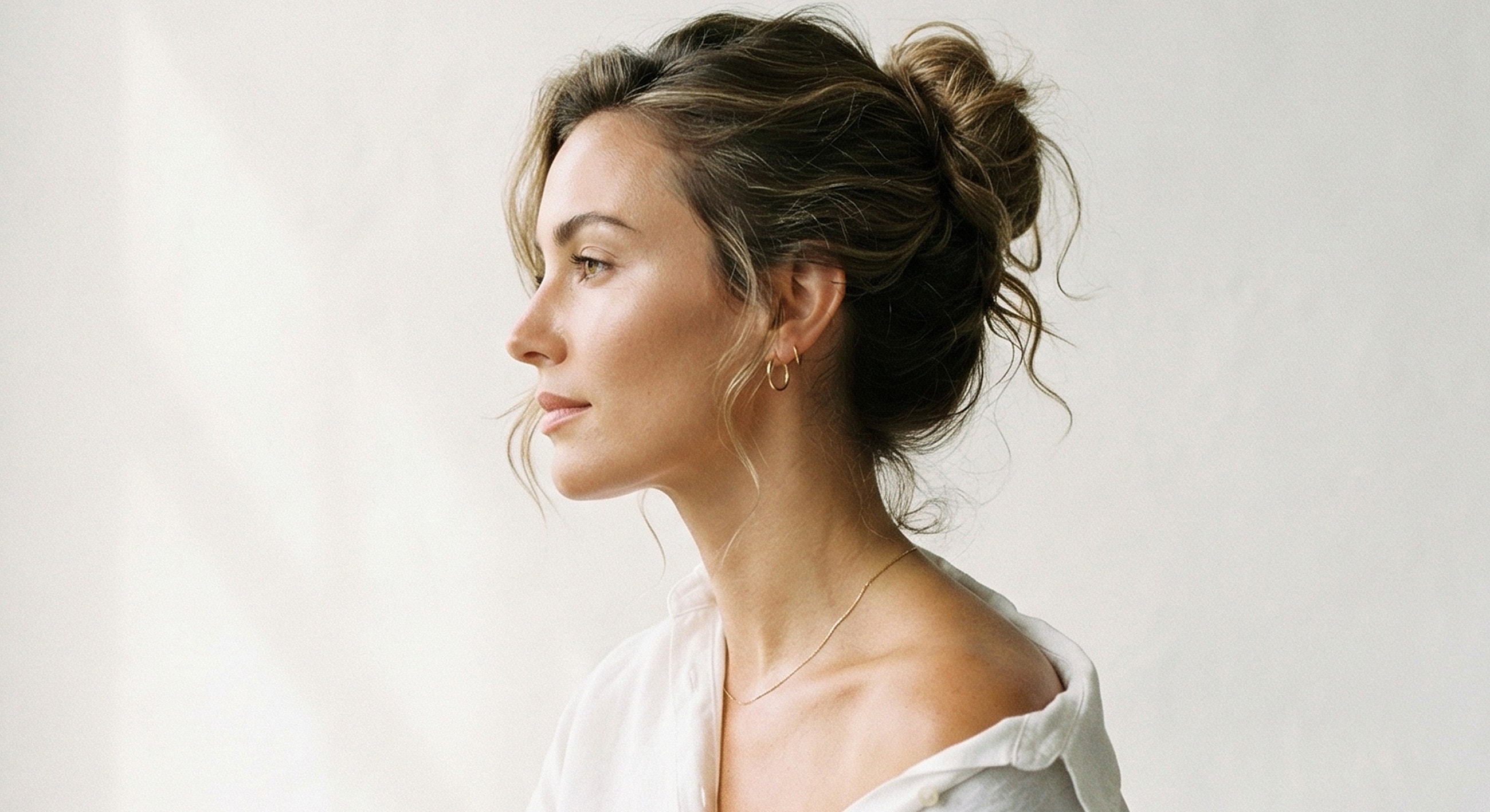 Profile portrait of a woman with wavy hair.
